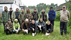 Uczestnicy biwaku pozujący do zdjęcia z pisklętami bocianów, które zostały wcześniej zaobrączkowane